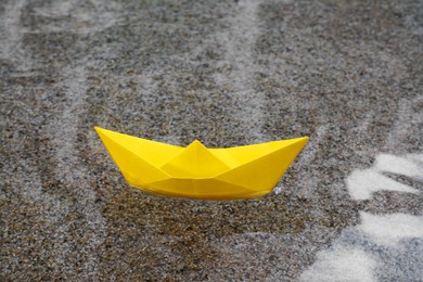 Photo of Beautiful yellow paper boat on water outdoors