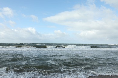 Photo of Picturesque view of wavy sea on cloudy day