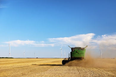 Photo of Modern combine harvester working in agricultural field