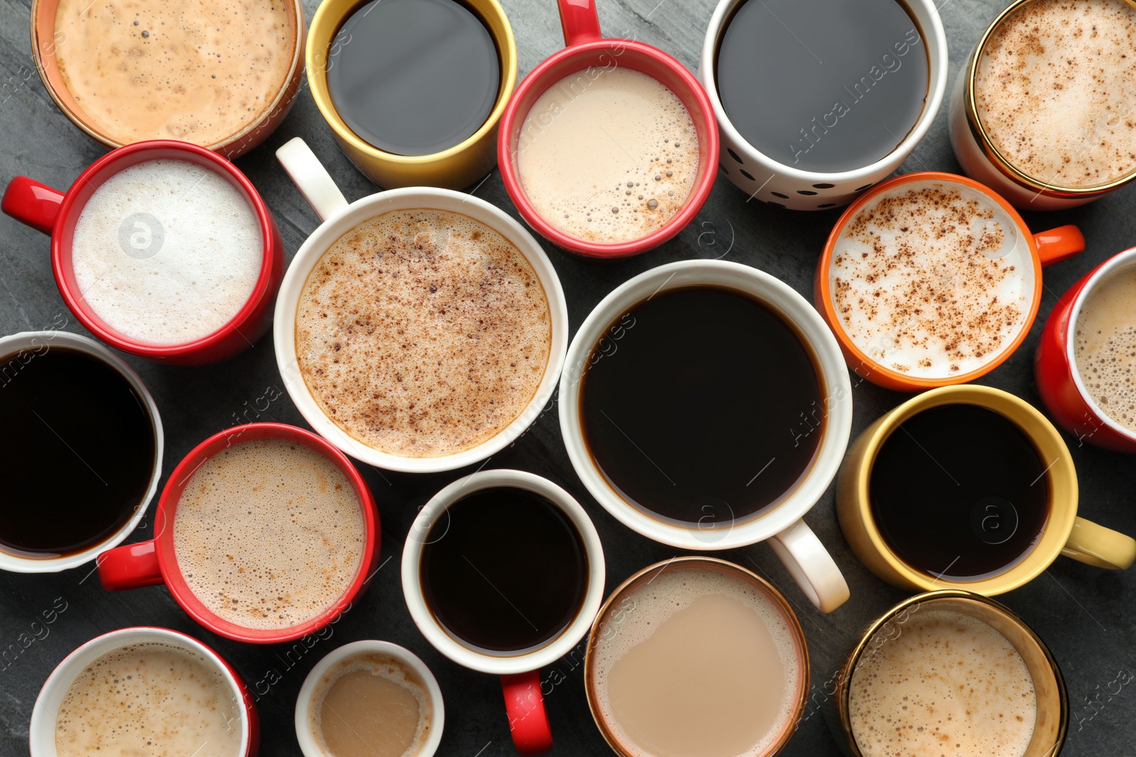 Photo of Many cups of different coffees on table, flat lay