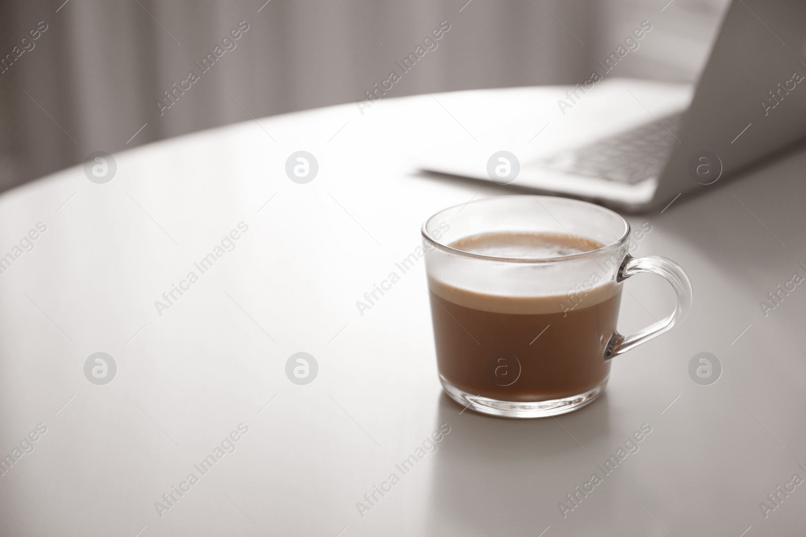 Photo of Cup of hot coffee on white table indoors in morning. Space for text