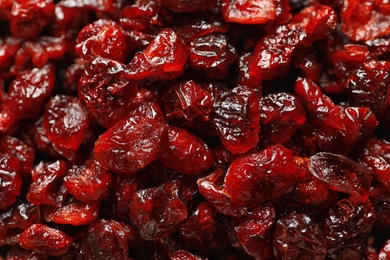 Tasty cranberries as background, top view. Dried fruits as healthy snack