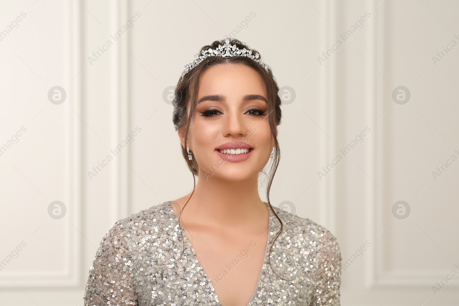 Photo of Beautiful young woman wearing luxurious tiara indoors