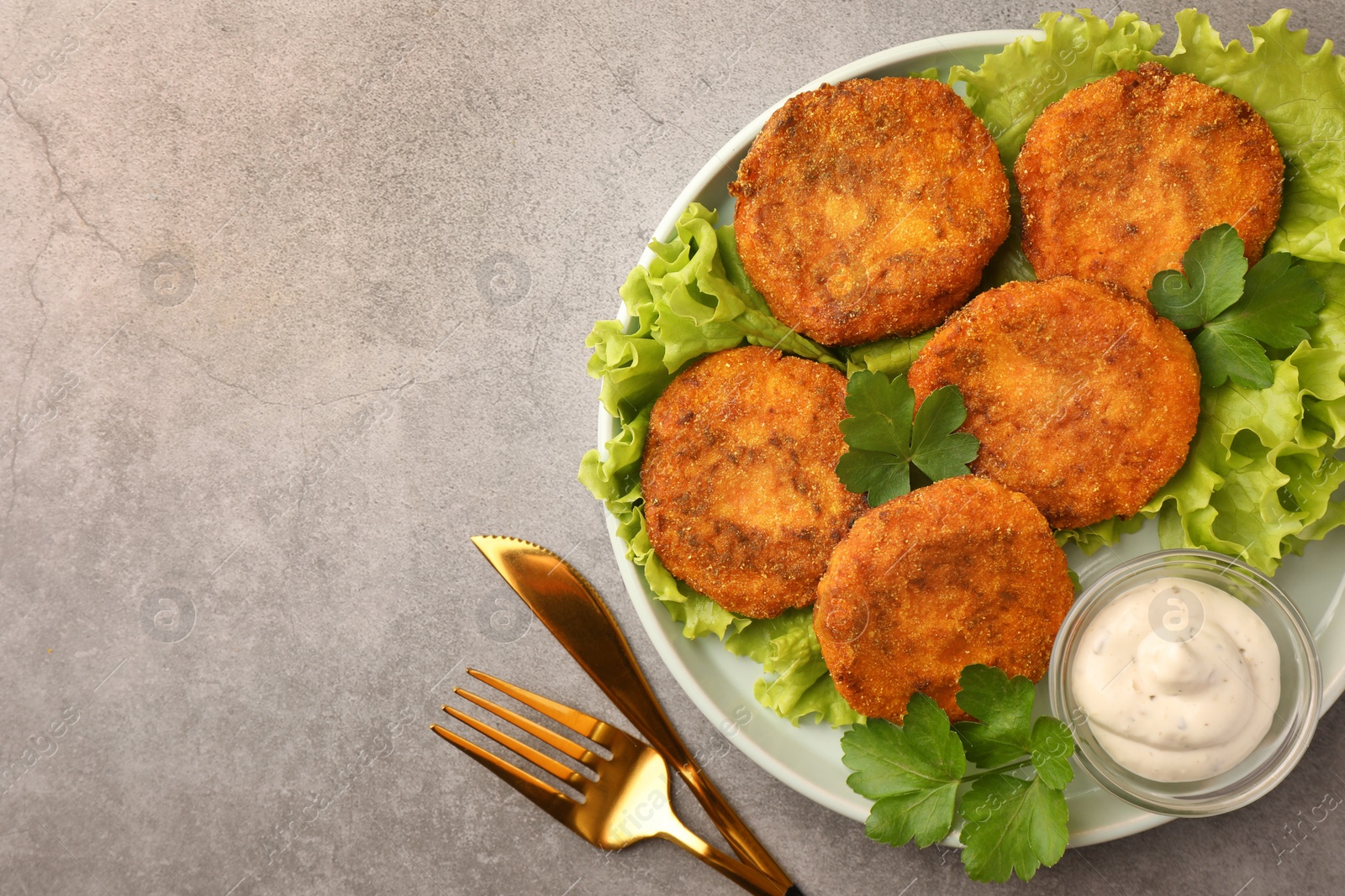 Photo of Tasty vegan cutlets served with sauce on light grey table, flat lay. Space for text
