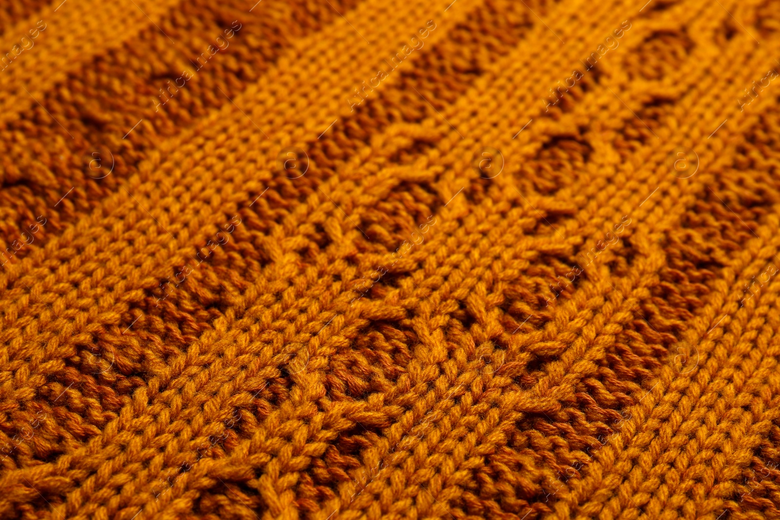 Photo of Beautiful orange knitted fabric as background, closeup