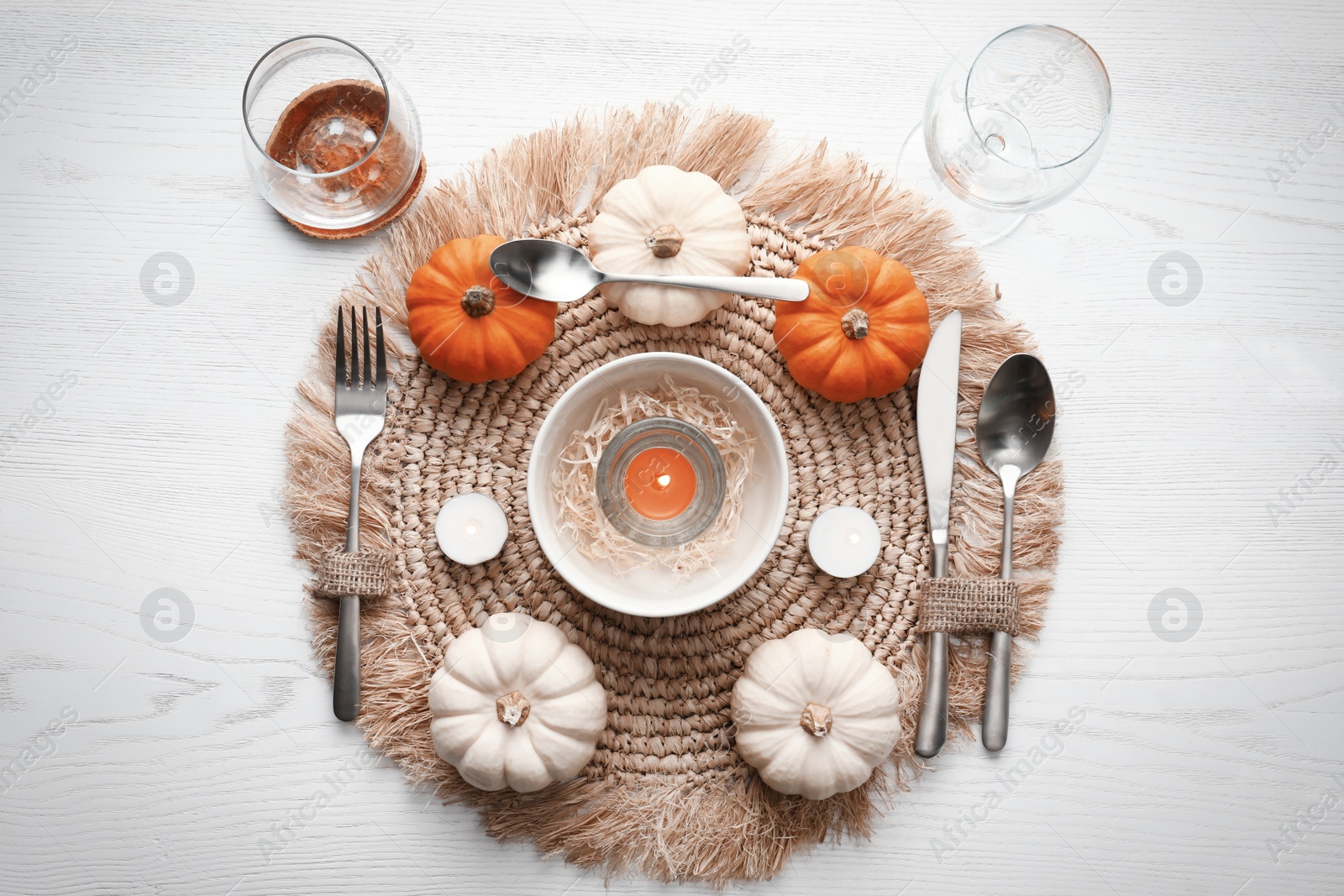 Photo of Autumn table setting with pumpkins on white wooden background, flat lay