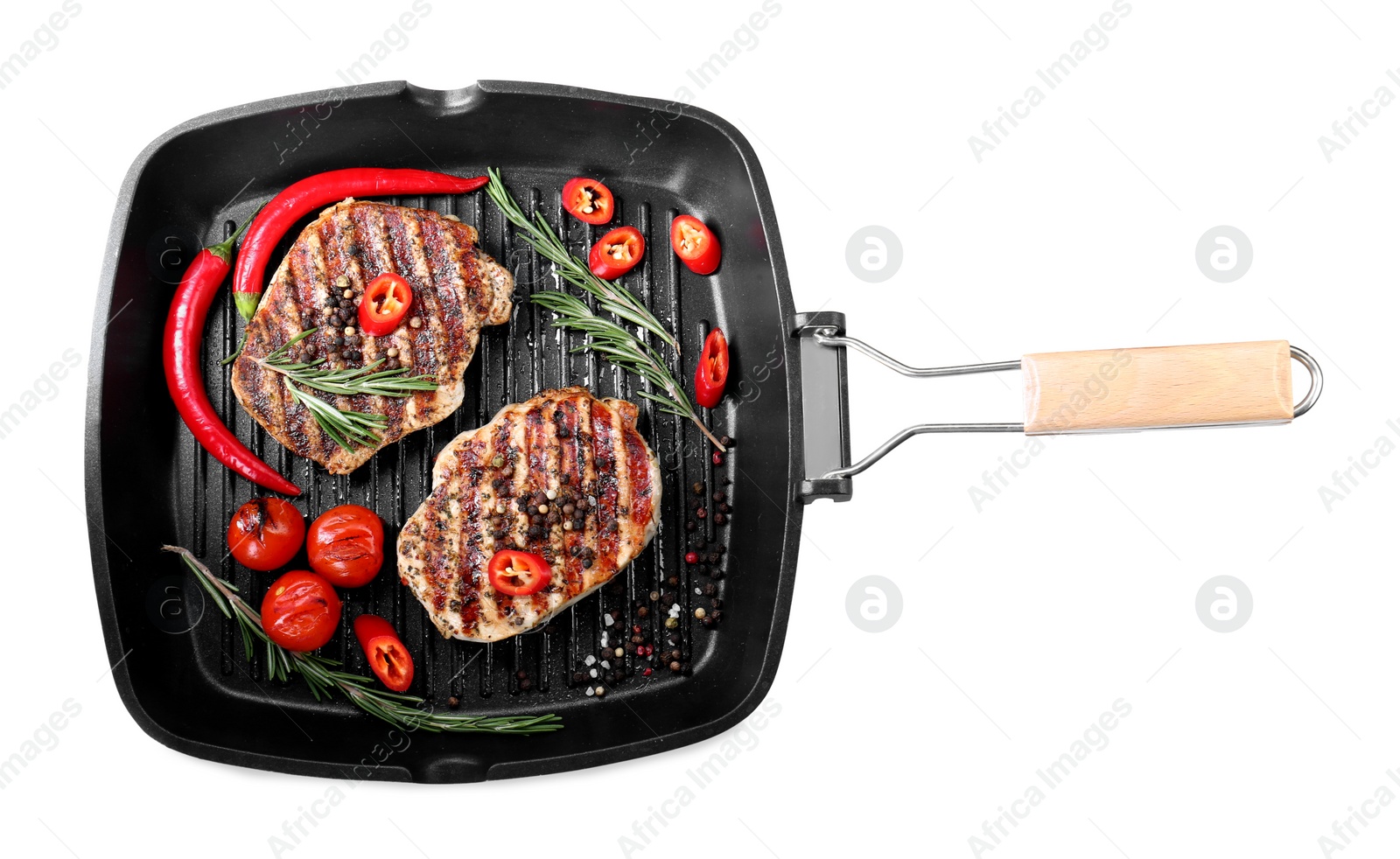 Photo of Grill pan with delicious pork steaks, spices and vegetables isolated on white, top view