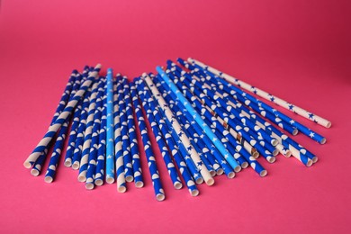 Photo of Many paper drinking straws on pink background