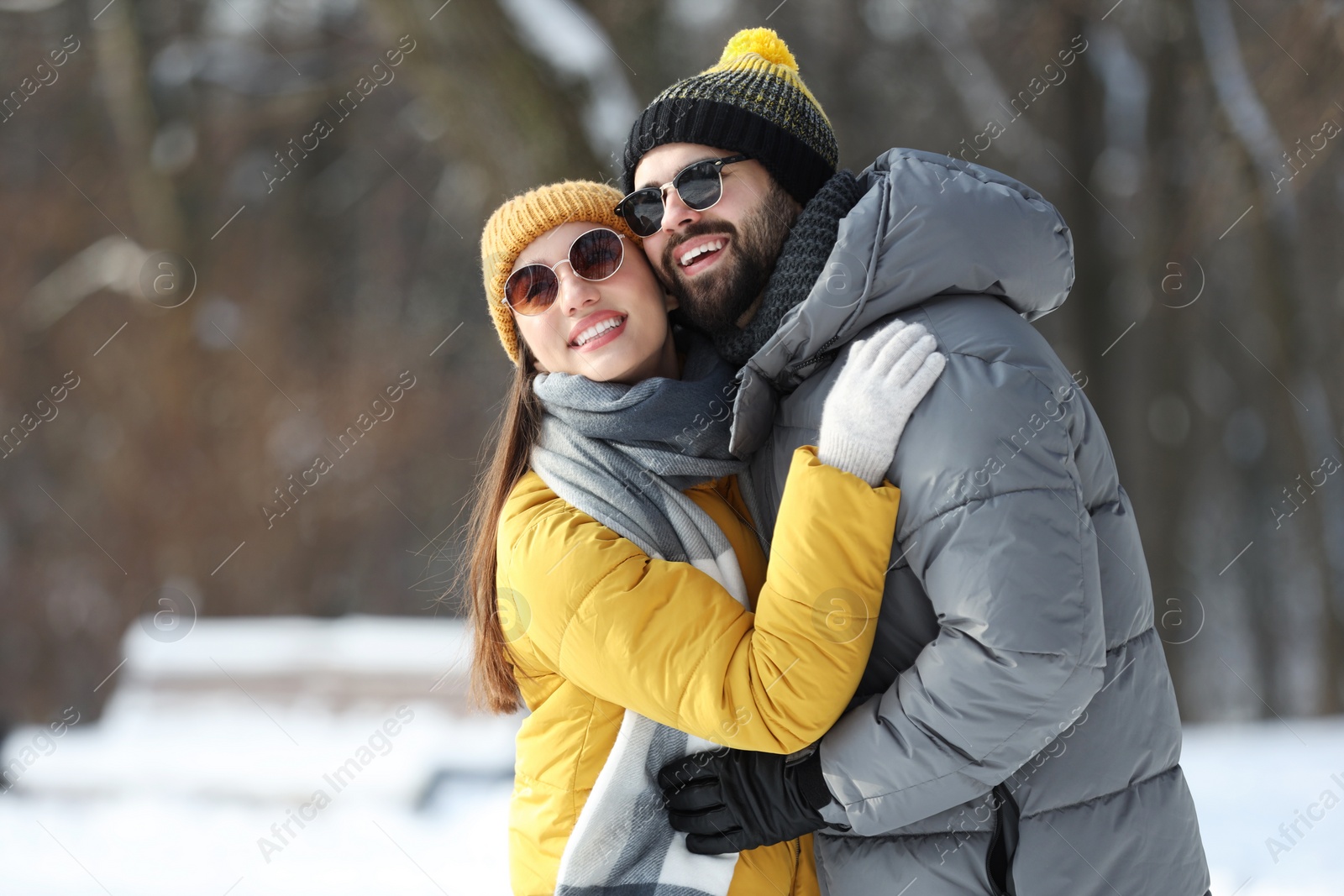 Photo of Beautiful happy couple outdoors on winter day. Space for text