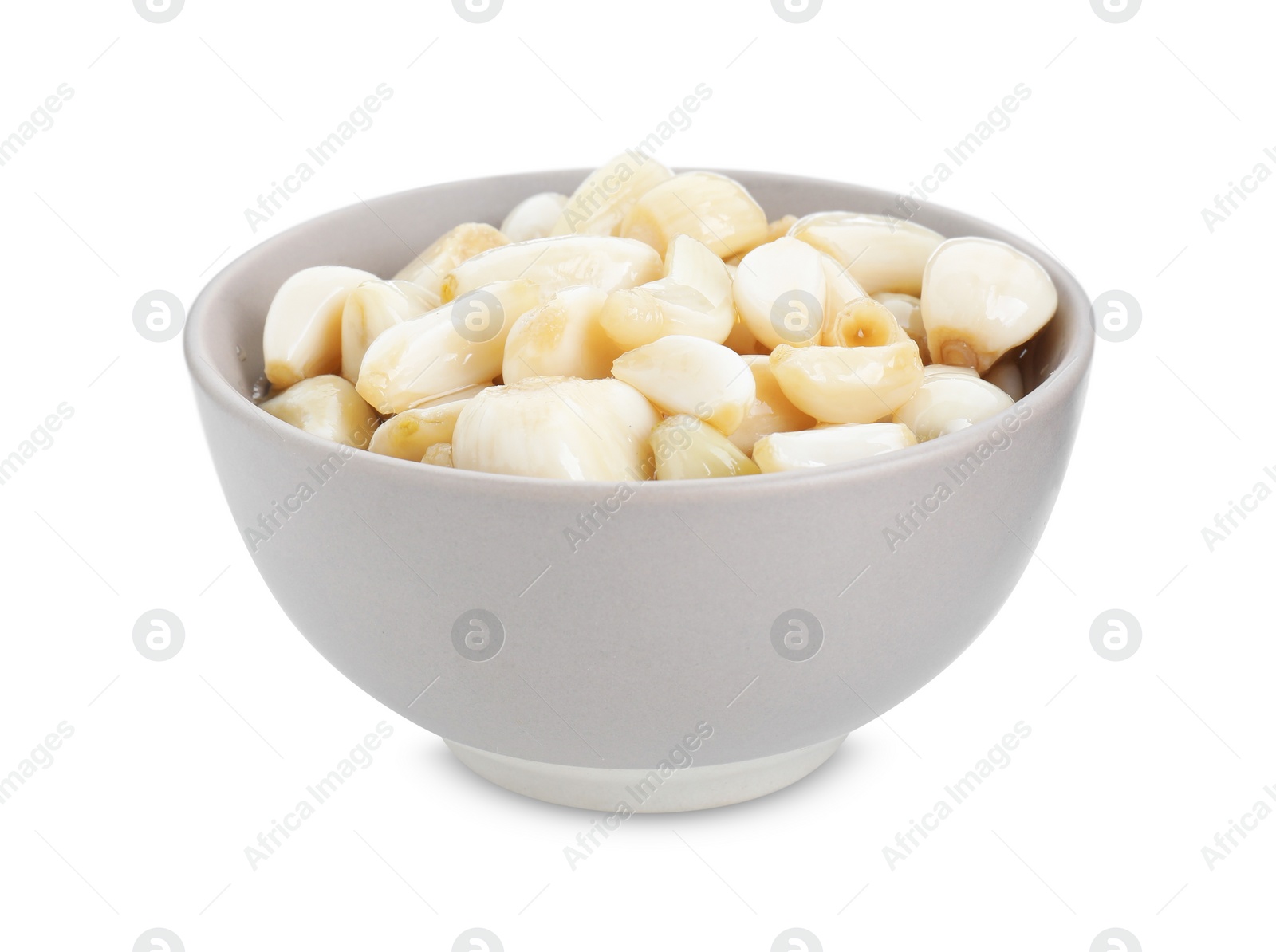 Photo of Peeled garlic cloves with honey in bowl isolated on white