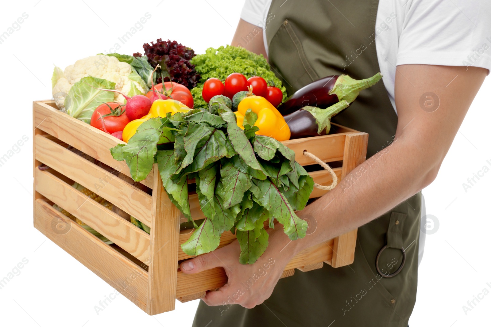 Photo of Harvesting season. Farmer holding wooden crate with vegetables on white background, closeup