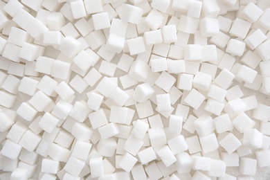 Refined sugar cubes as background, top view