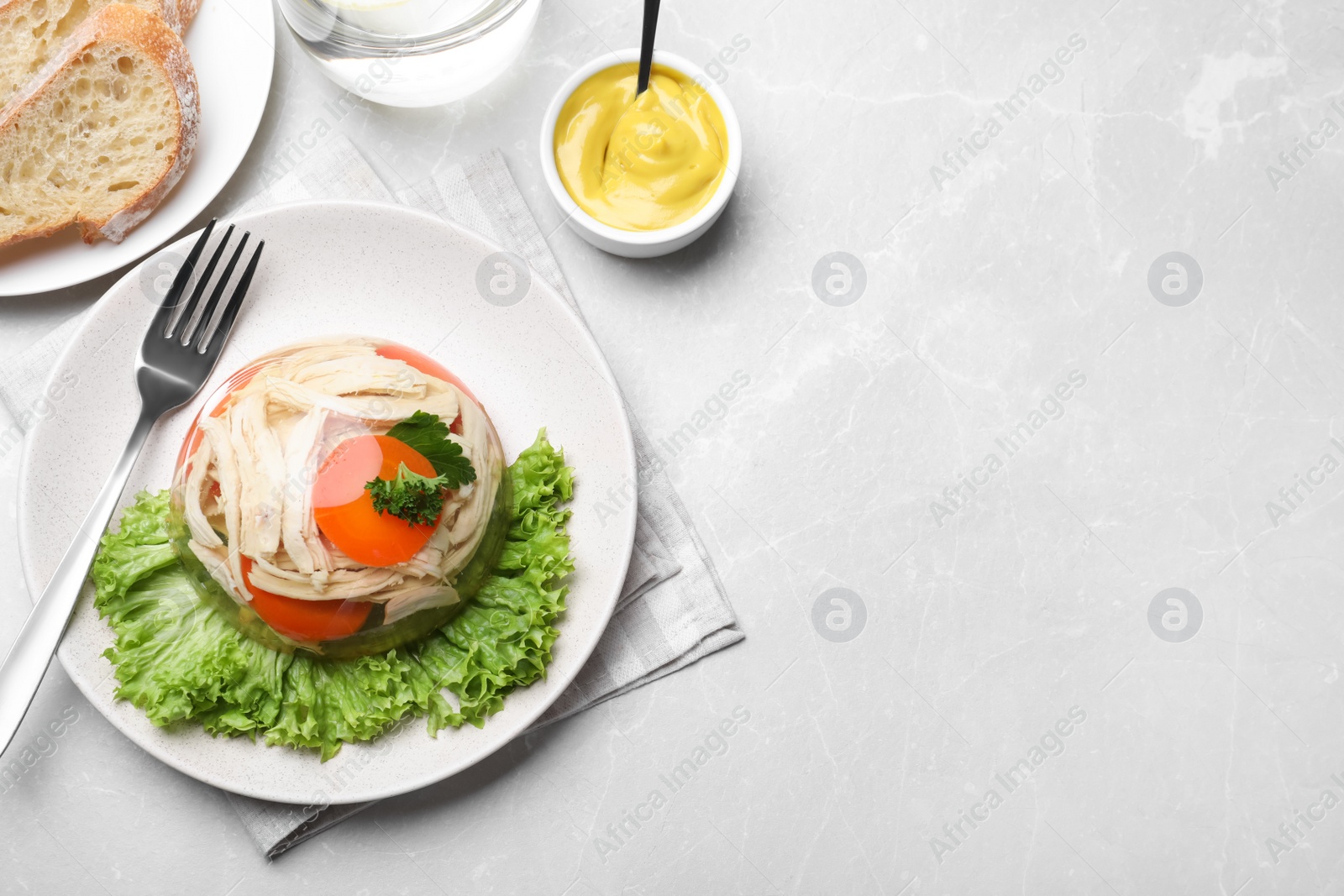 Photo of Delicious chicken aspic served on light table, flat lay. Space for text