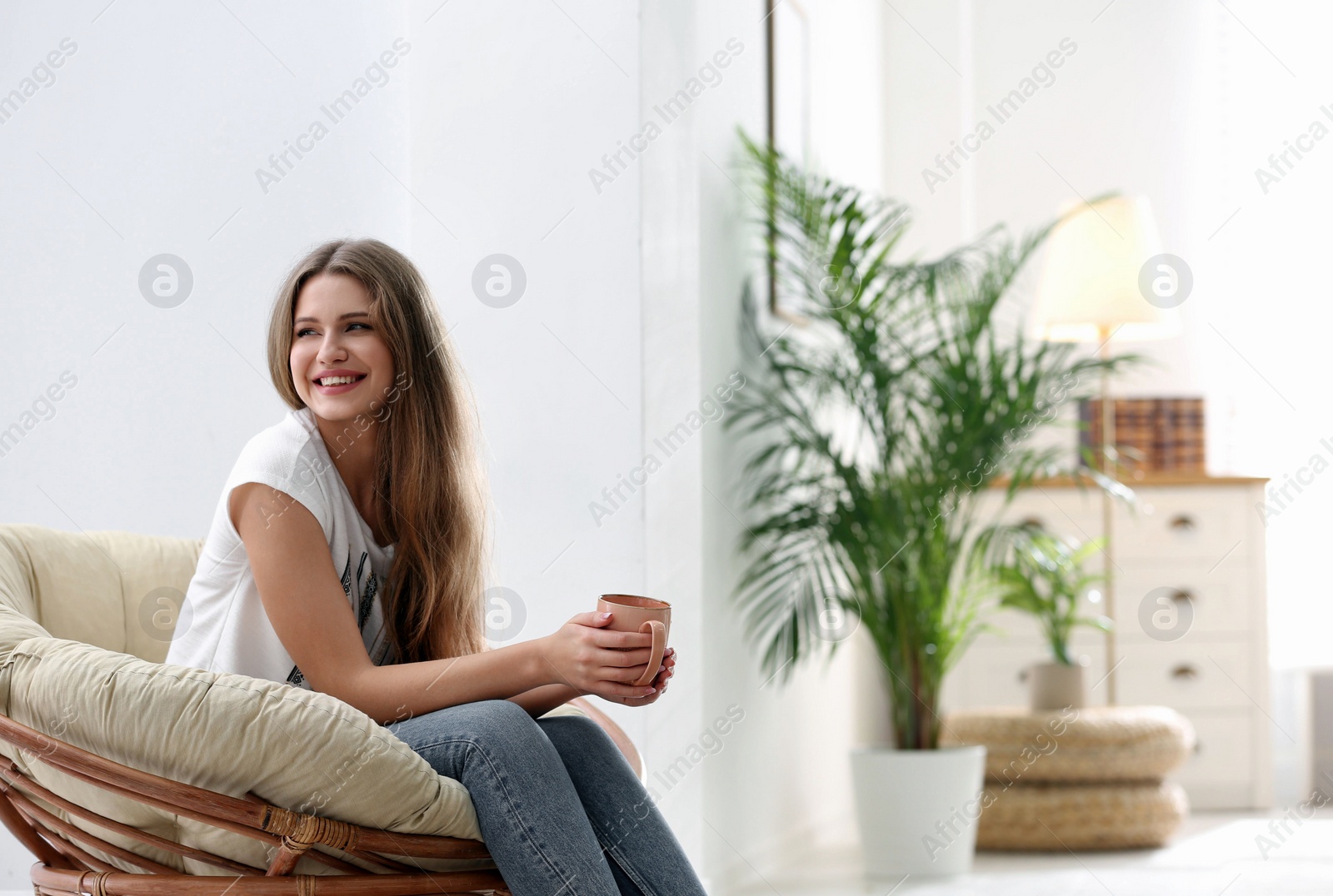 Photo of Young woman resting in armchair at home