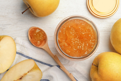 Homemade delicious apple jam on white wooden table, flat lay