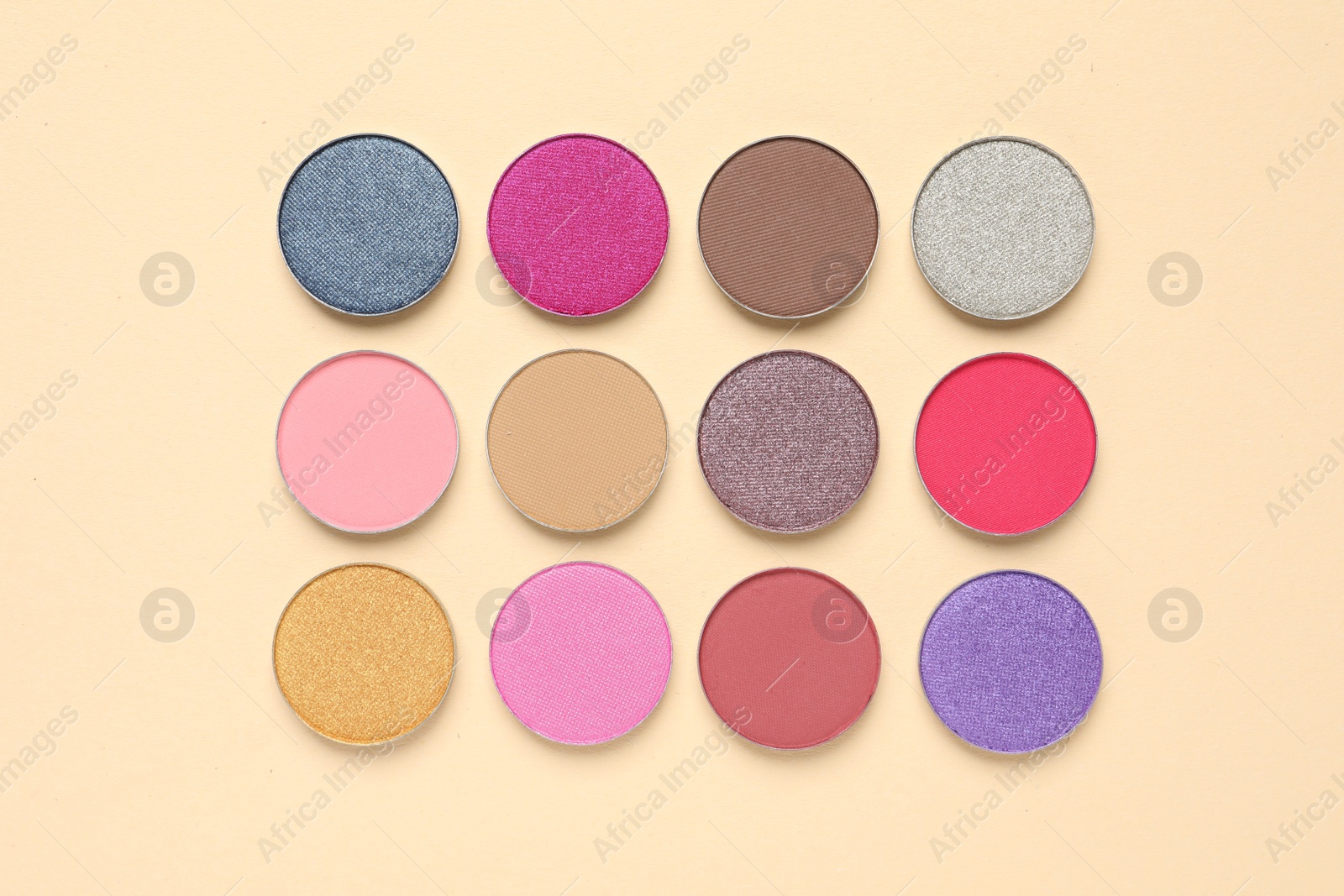 Photo of Different beautiful eye shadows on beige background, flat lay