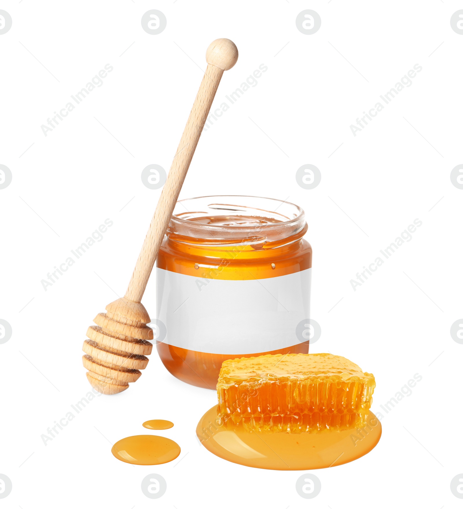 Image of Sweet honey in glass jar with blank label, wooden honey dipper and piece of honeycomb on white background. Mockup for design