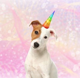 Cute dog with rainbow unicorn horn on blurred sparkling background