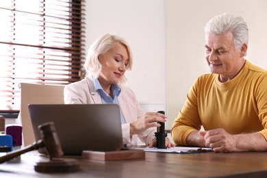 Female notary working with client in office