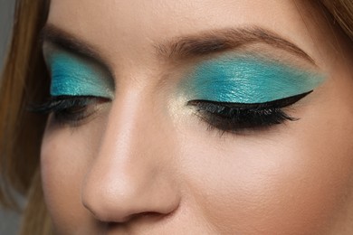 Photo of Young woman with evening makeup, closeup. Eye shadow product