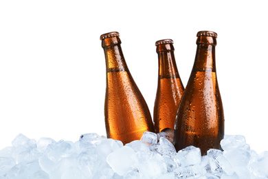 Photo of Ice cubes and bottles of beer on white background