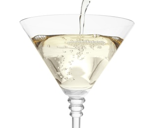 Photo of Pouring martini from bottle into glass on white background