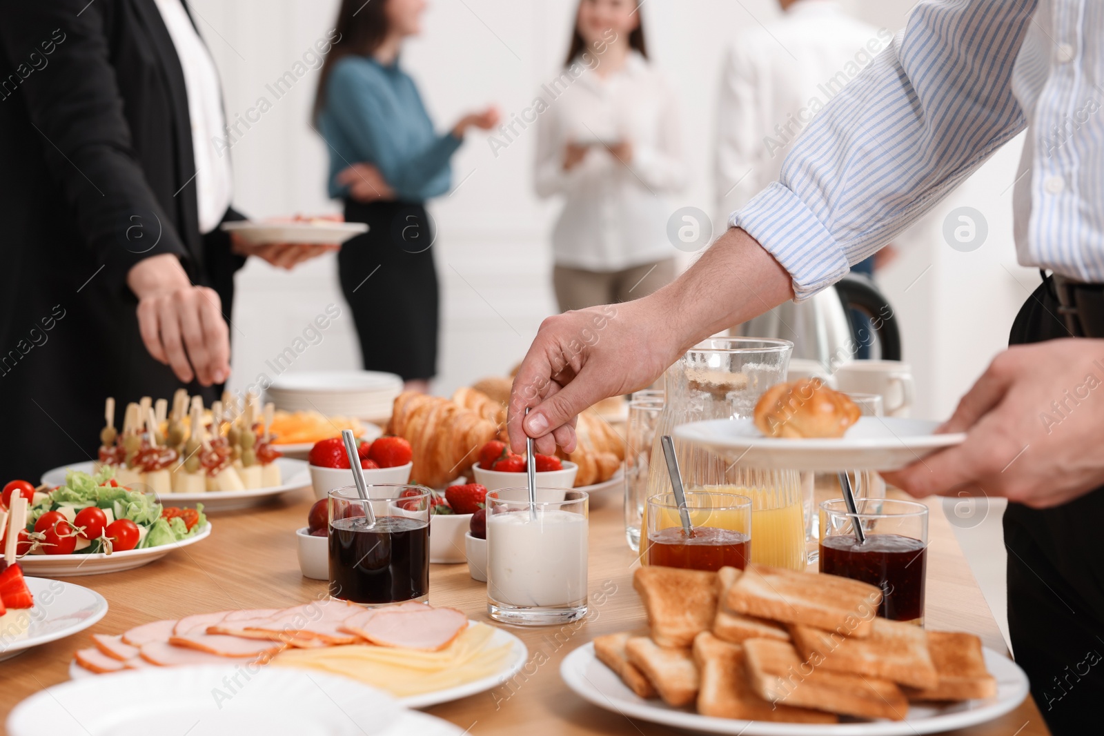 Photo of Coworkers having business lunch in restaurant, closeup