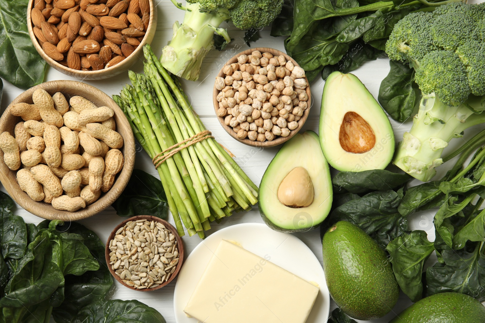 Photo of Different products rich in vitamin E on white wooden table, flat lay