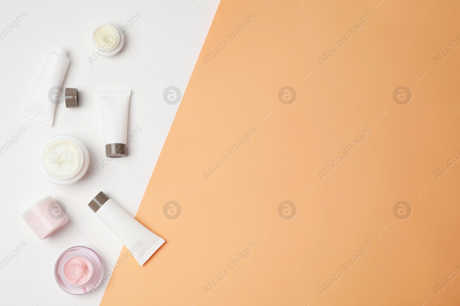 Photo of Flat lay composition with cosmetic products on color background