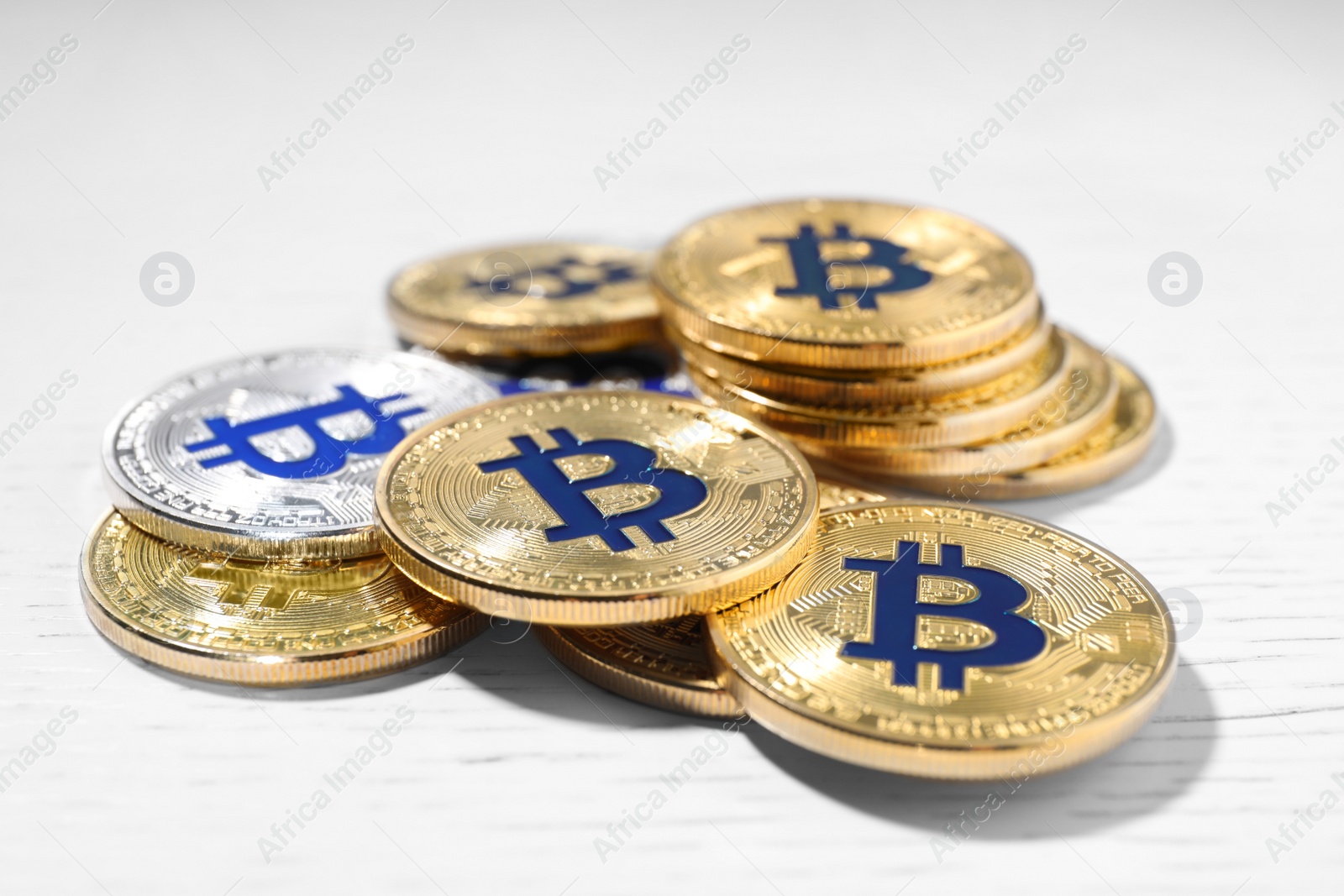Photo of Golden and silver bitcoins on wooden table, closeup. Digital currency