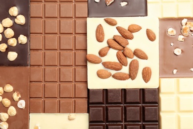 Different delicious chocolate bars as background