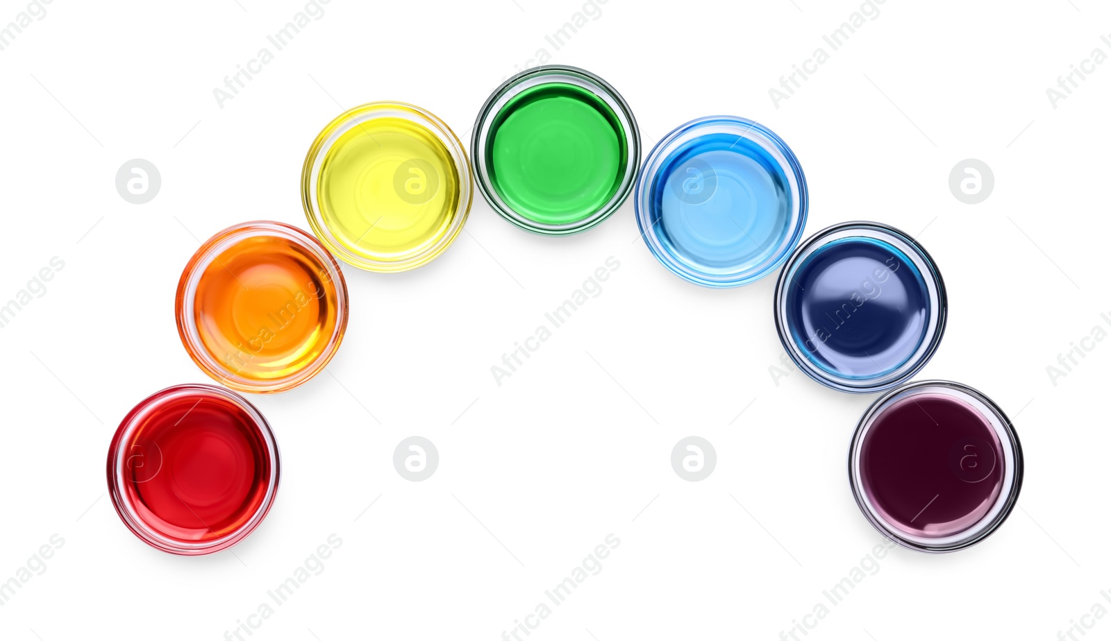 Photo of Glass bowls with different food coloring on white background, top view