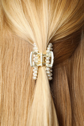 Photo of Woman with beautiful hair claw, closeup view