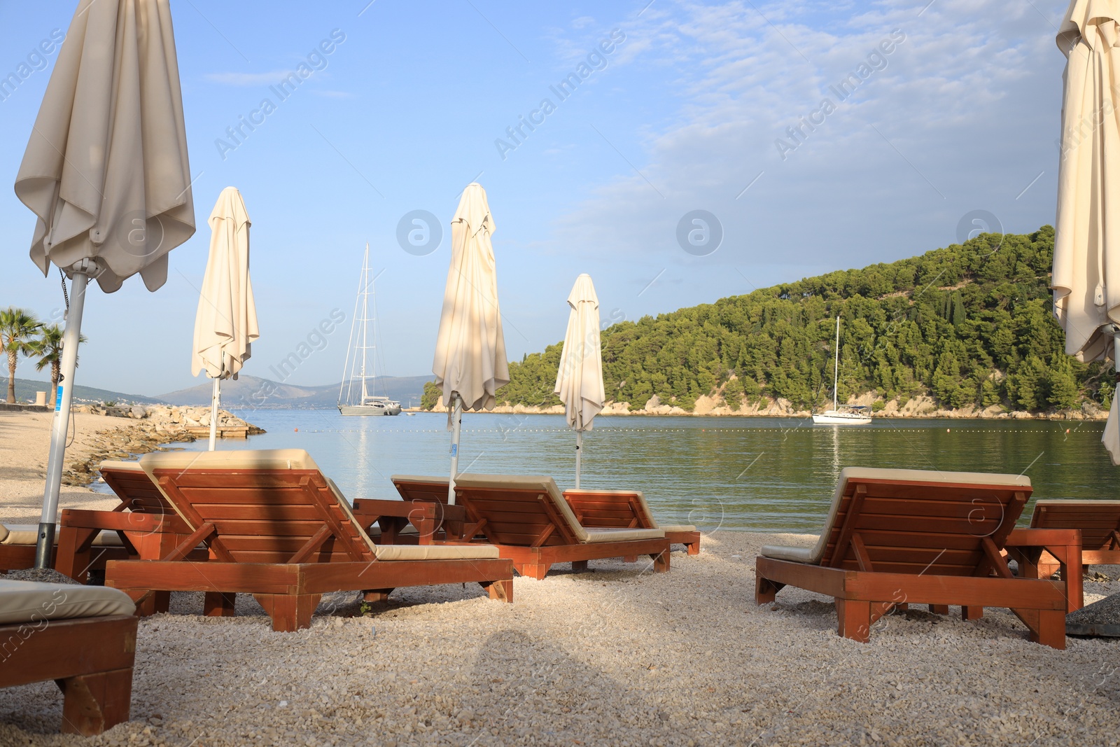 Photo of Many beach umbrellas and sunbeds at resort