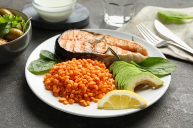 Photo of Healthy food high in vegetable fats on grey textured table, closeup