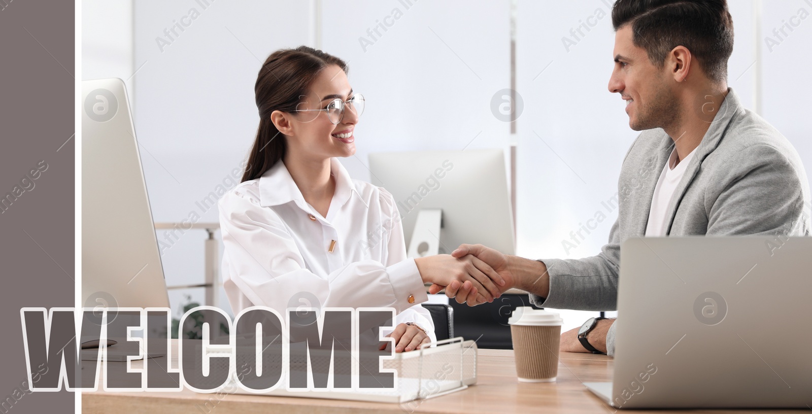 Image of Welcome to team. Employee shaking hands with intern in office