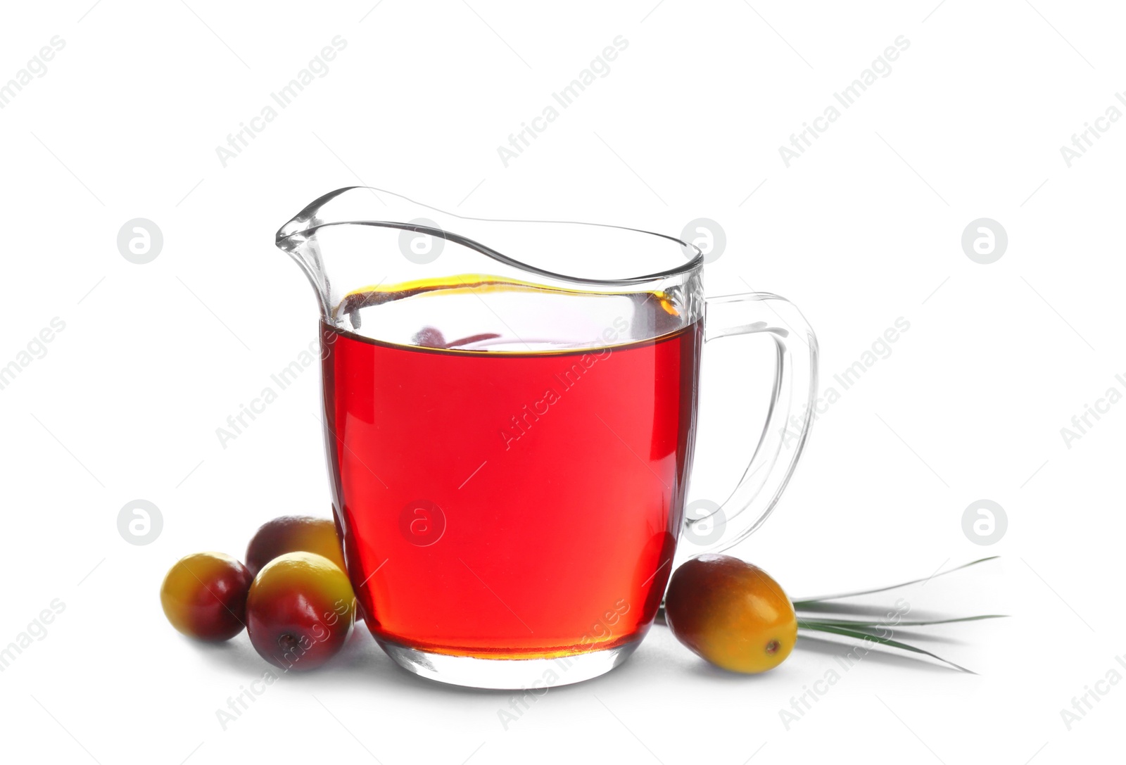 Photo of Palm oil in glass jug, tropical leaf and fruits isolated on white