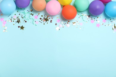 Flat lay composition with balloons and confetti on light blue background, space for text. Birthday decor