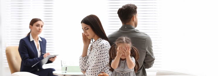 Image of Professional psychologist working with family in office