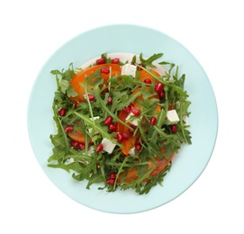 Photo of Delicious persimmon salad with pomegranate and arugula isolated on white, top view