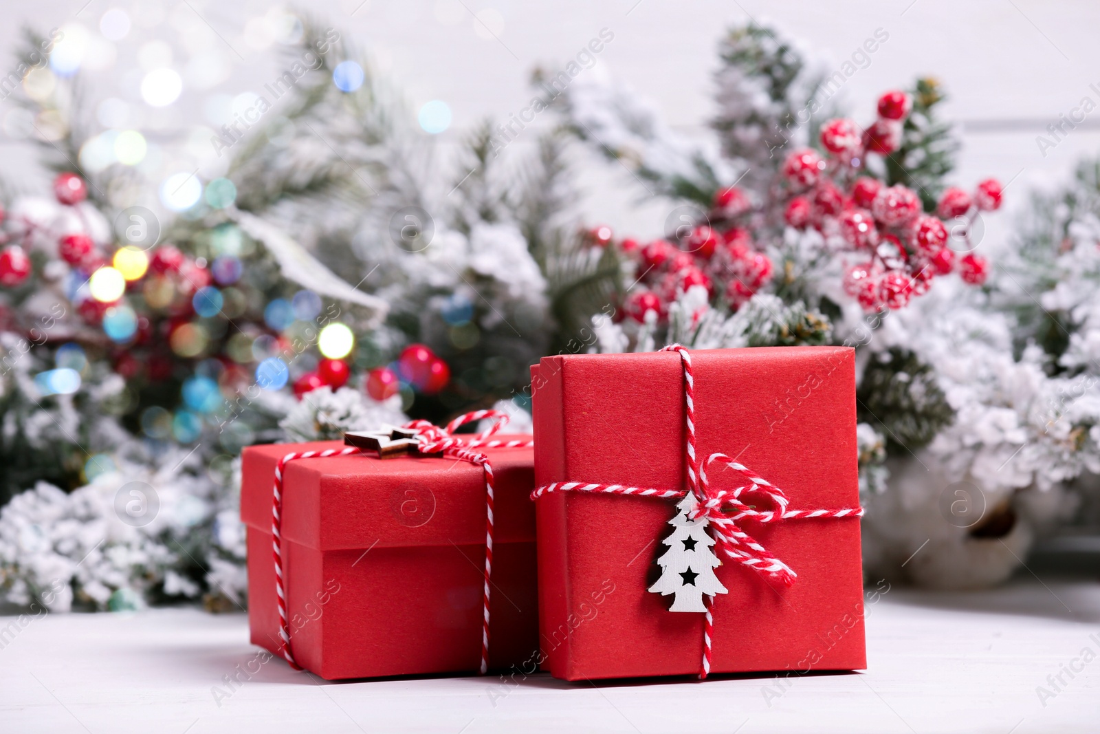 Photo of Beautiful gift boxes and Christmas decor on white table