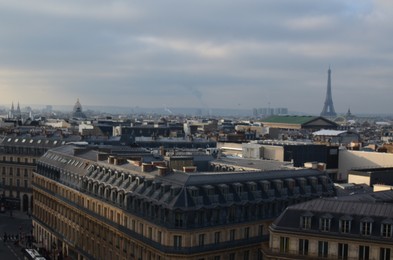 Photo of Paris, France - December 10, 2022: Panoramic view of city with Eiffel Tower on cloudy day