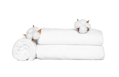 Soft terry towels with cotton flowers on white background