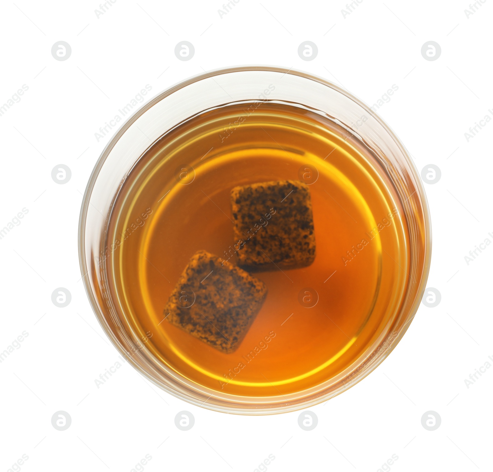 Photo of Glass of expensive whiskey with stones on white background, top view