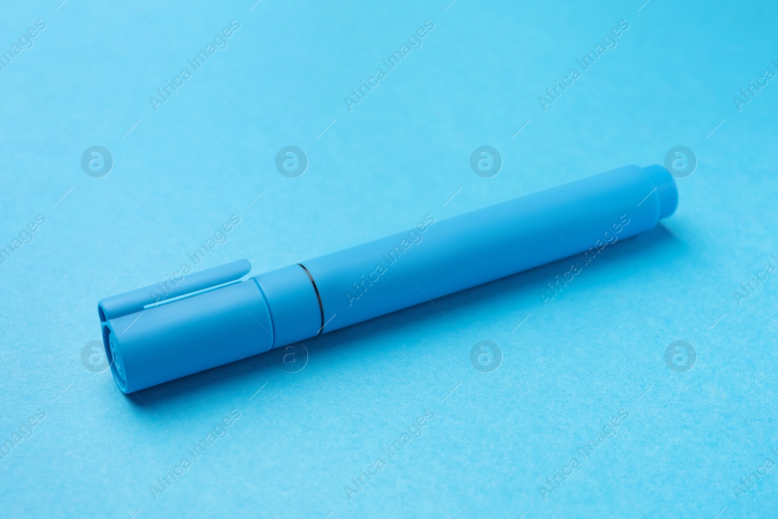 Photo of Bright color marker on light blue background