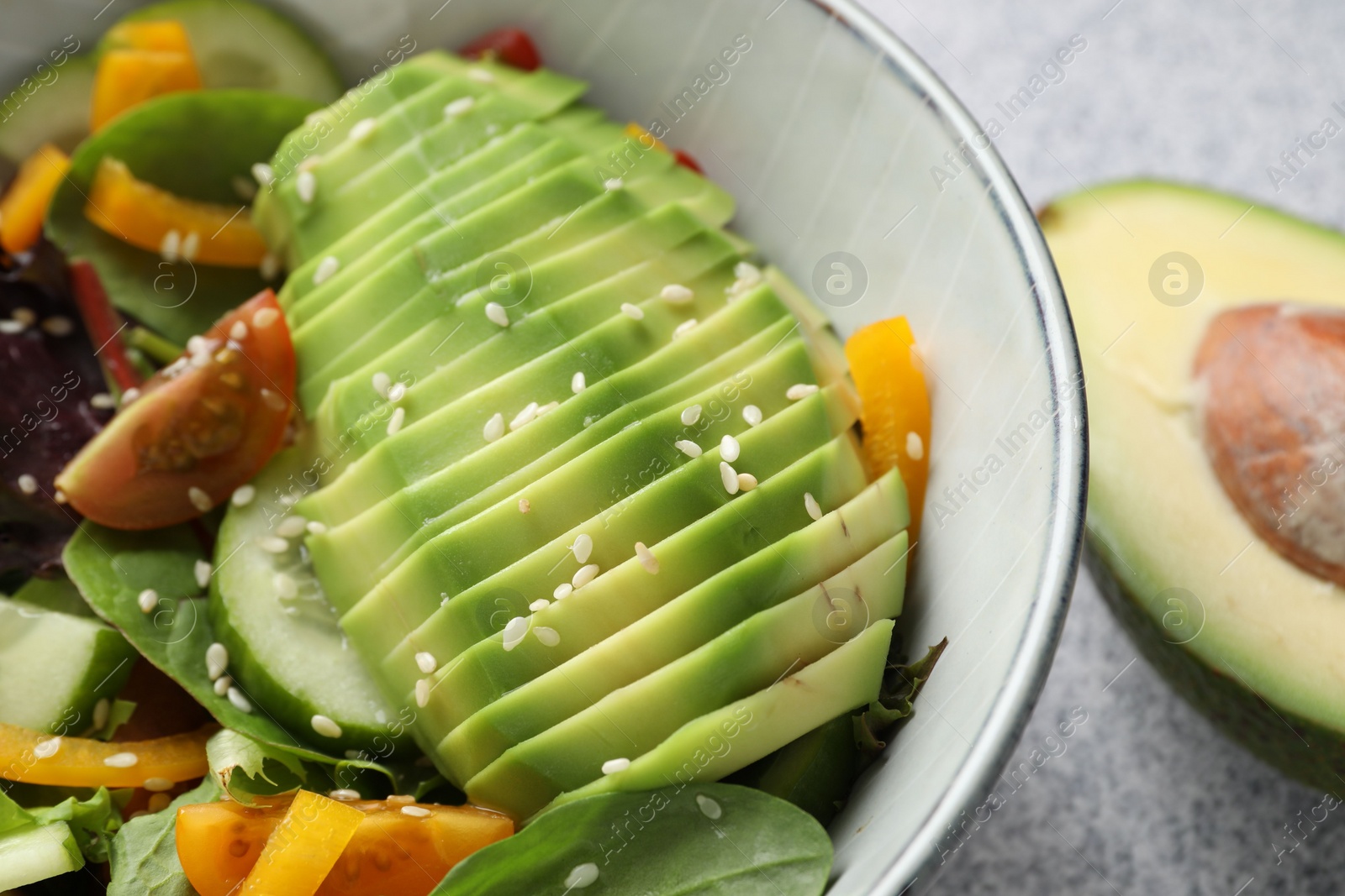 Photo of Healthy dish high in vegetable fats on light table, closeup