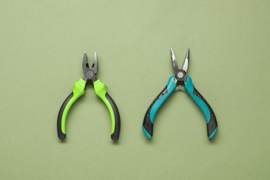 Two pliers on olive background, flat lay