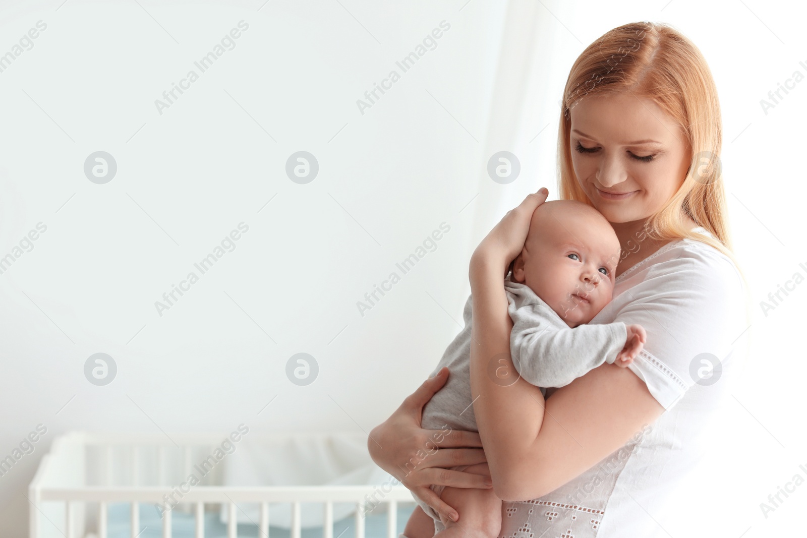 Photo of Happy mother and her baby at home