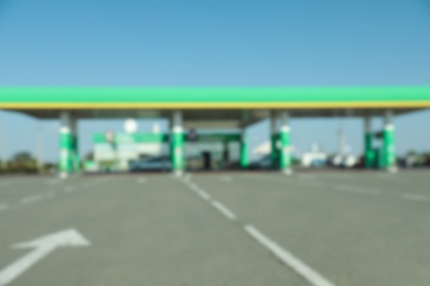 Photo of Blurred view of modern gas station with convenience store beside the road