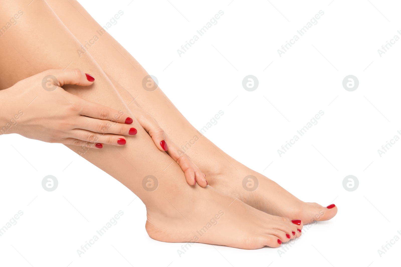 Photo of Woman with stylish red toenails after pedicure procedure isolated on white, closeup